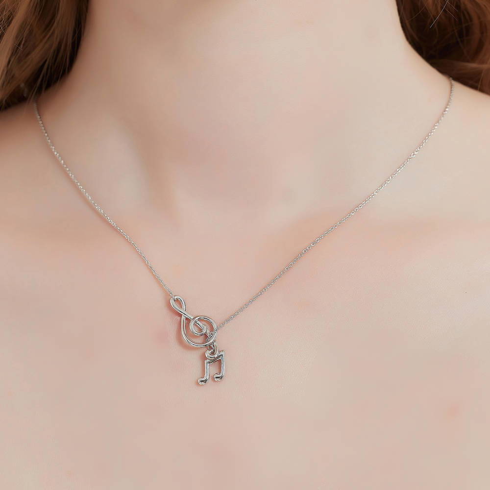 Model wearing Treble Clef Music Note Lariat Necklace in Sterling Silver, 2 of 10