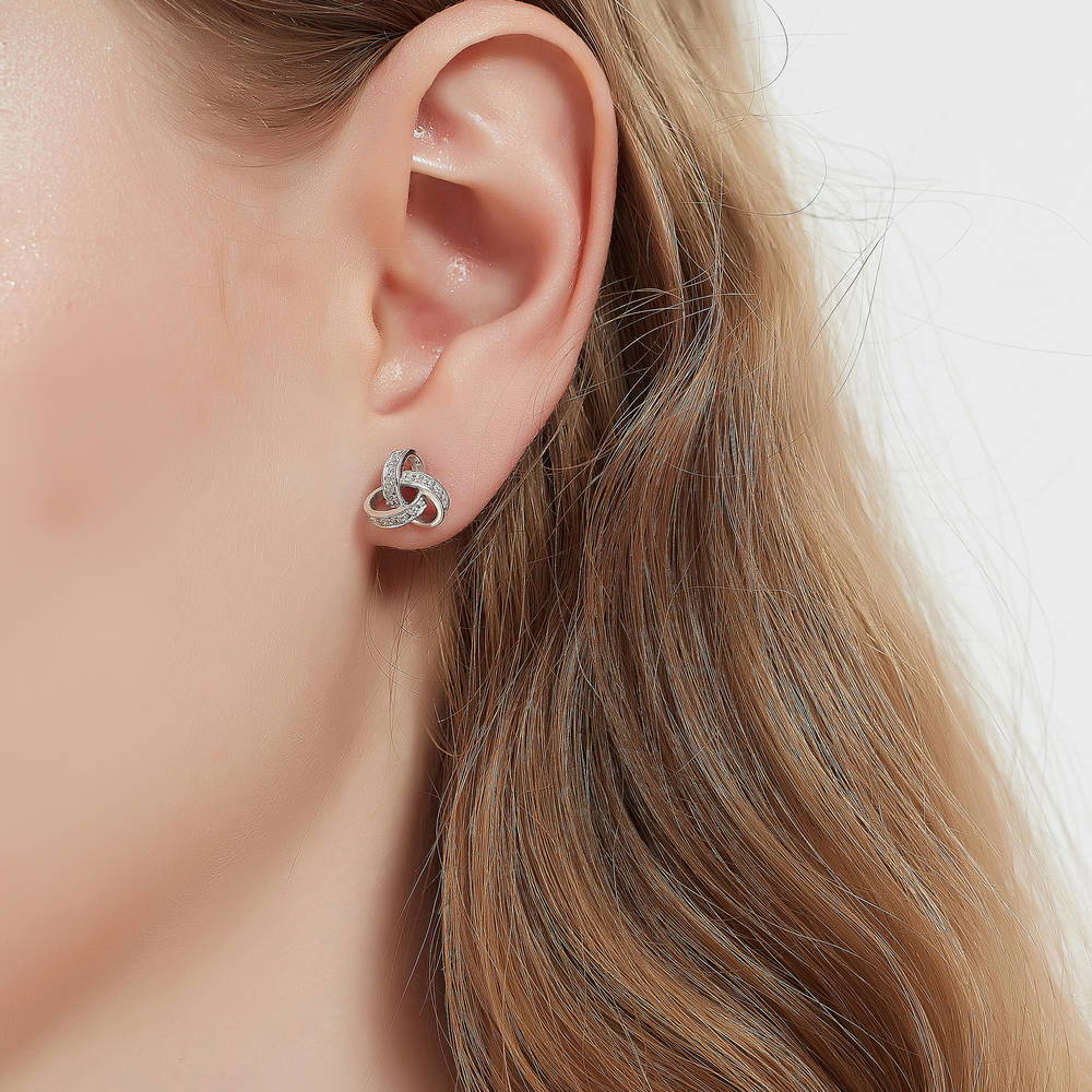 Model wearing Love Knot CZ Stud Earrings in Sterling Silver, 3 of 8