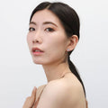 Model wearing Bow Tie Ribbon CZ Stud Earrings in Sterling Silver, Style 1