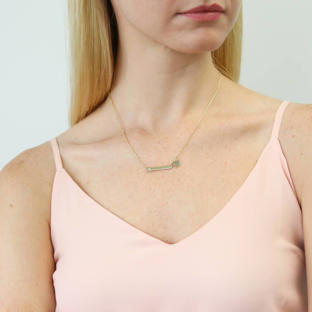 Model wearing Bar Heart CZ Pendant Necklace in Gold Flashed Sterling Silver, 2 of 7