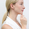 Model wearing Flower CZ Stud Earrings in Sterling Silver, Yellow Gold Flashed