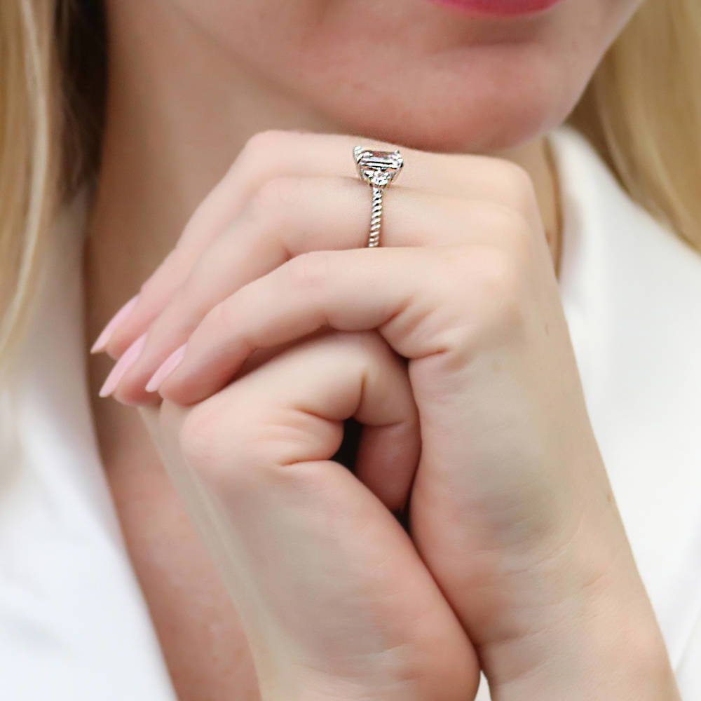 Model wearing 3-Stone Woven 2.6ct Emerald Cut CZ Ring in Sterling Silver, 7 of 10