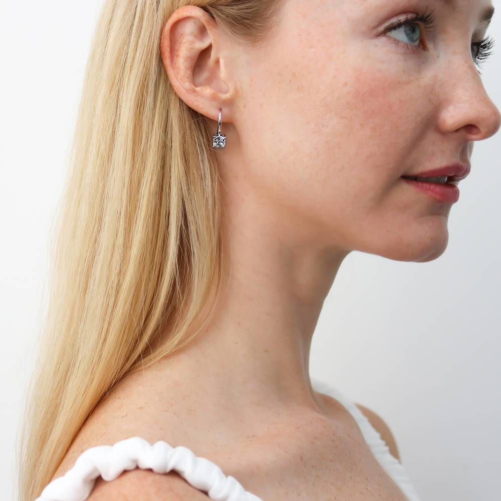 Model wearing Solitaire 2.5ct Checkerboard Cushion CZ Earrings in Sterling Silver, 3 of 4