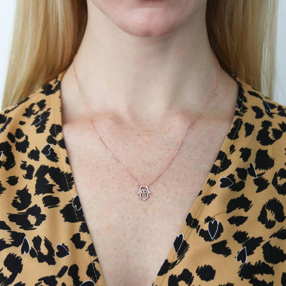 Model wearing Hamsa Hand Evil Eye CZ Necklace in Rose Gold Flashed Sterling Silver, 2 of 5