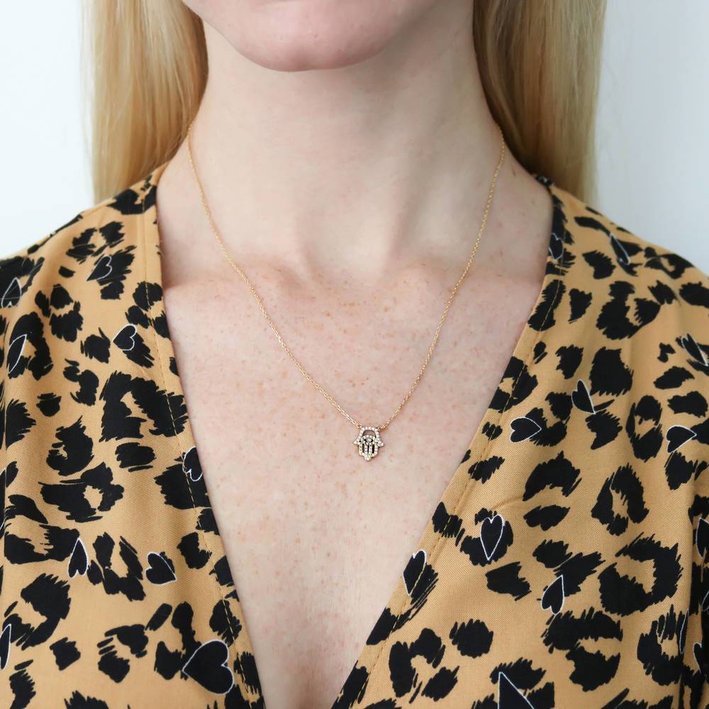 Model wearing Hamsa Hand Evil Eye CZ Pendant Necklace in Gold Flashed Sterling Silver, 2 of 5