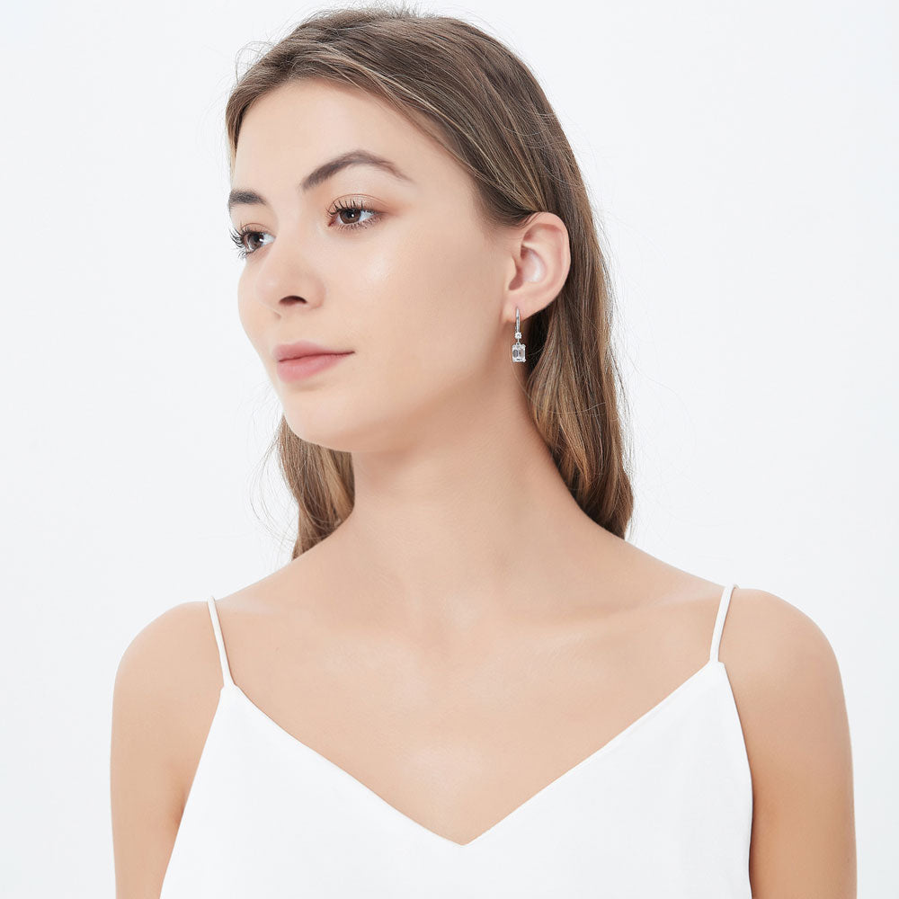 Model wearing Solitaire 6.8ct Emerald Cut CZ Earrings in Sterling Silver, 2 Pairs, 9 of 12