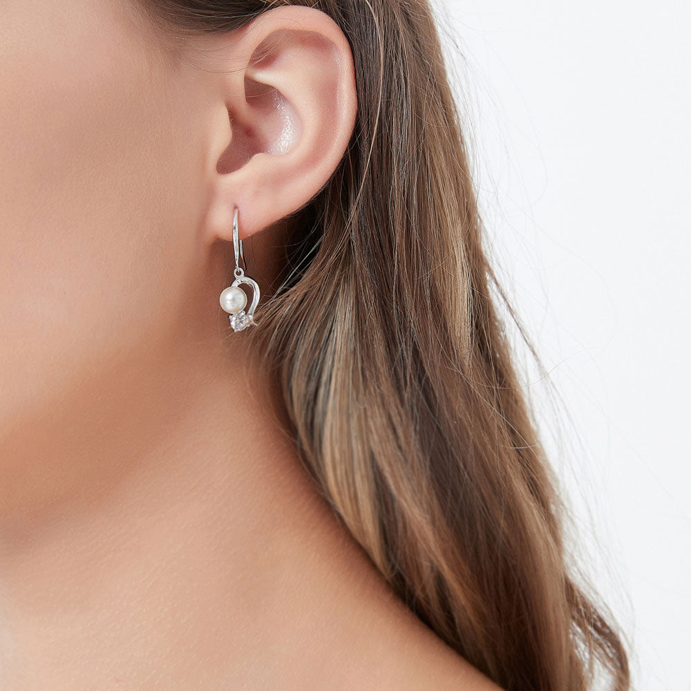 Model wearing Ball Bead Imitation Pearl Fish Hook Dangle Earrings in Sterling Silver, 2 of 5