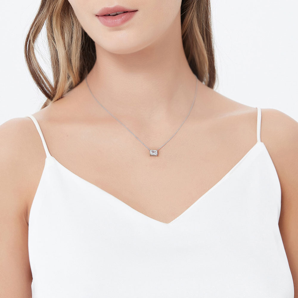 Model wearing Solitaire East-West 1.7ct Emerald Cut CZ Necklace in Sterling Silver, 4 of 6