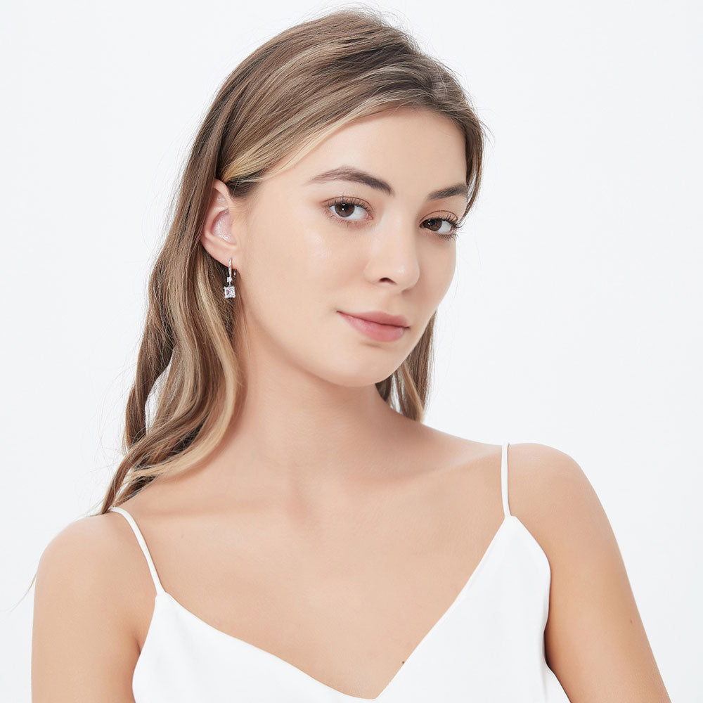 Model wearing Solitaire 3.2ct Princess CZ Leverback Earrings in Sterling Silver, 3 of 5
