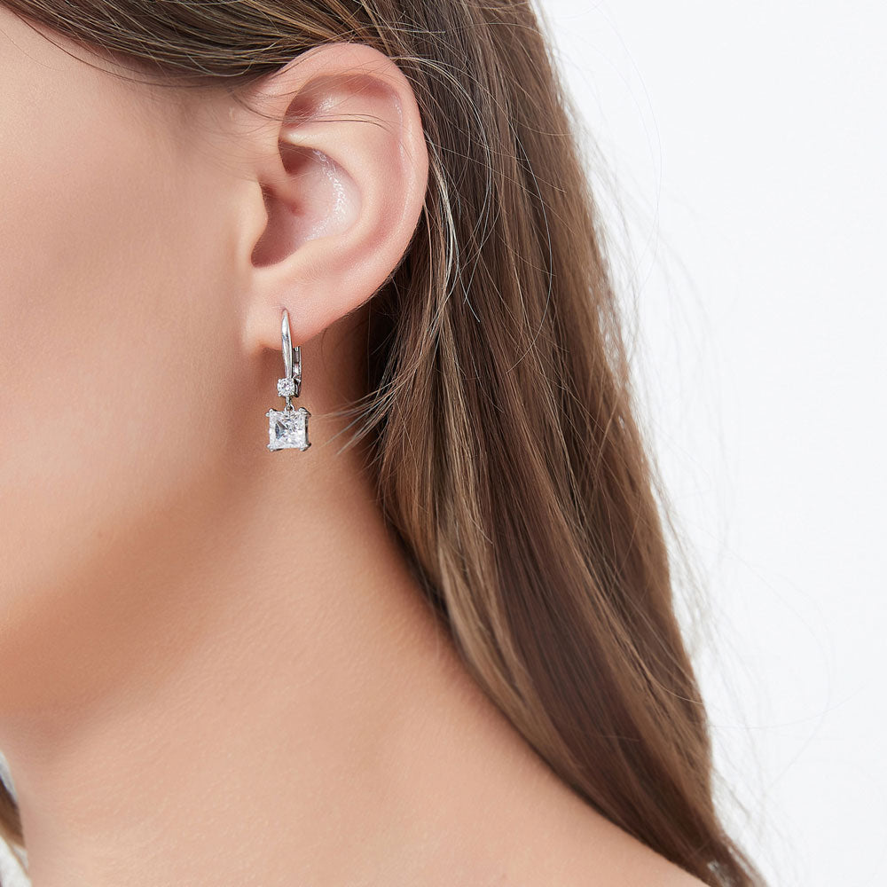 Model wearing Solitaire 3.2ct Princess CZ Leverback Earrings in Sterling Silver, 2 of 5