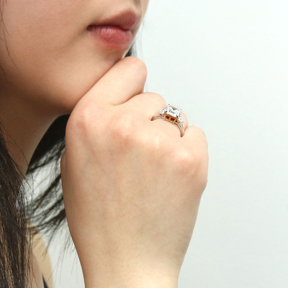 Model wearing 3-Stone Step Emerald Cut CZ Ring in Sterling Silver, 8 of 10