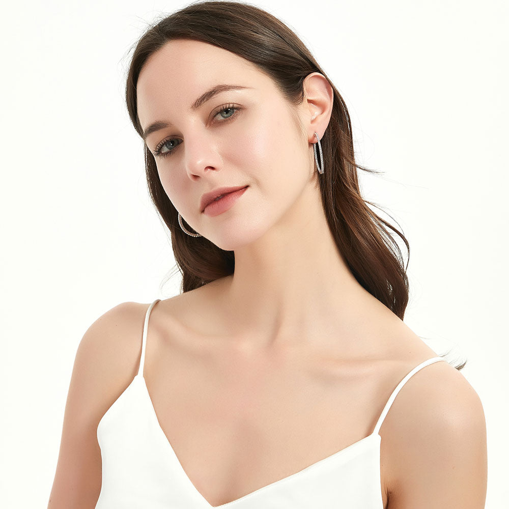 Model wearing CZ Medium Inside-Out Hoop Earrings in Sterling Silver 1.4 inch, 10 of 15
