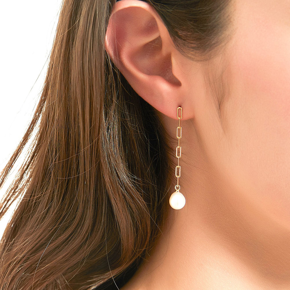 Model wearing Solitaire White Oval Cultured Pearl Earrings in Sterling Silver, 2 of 6