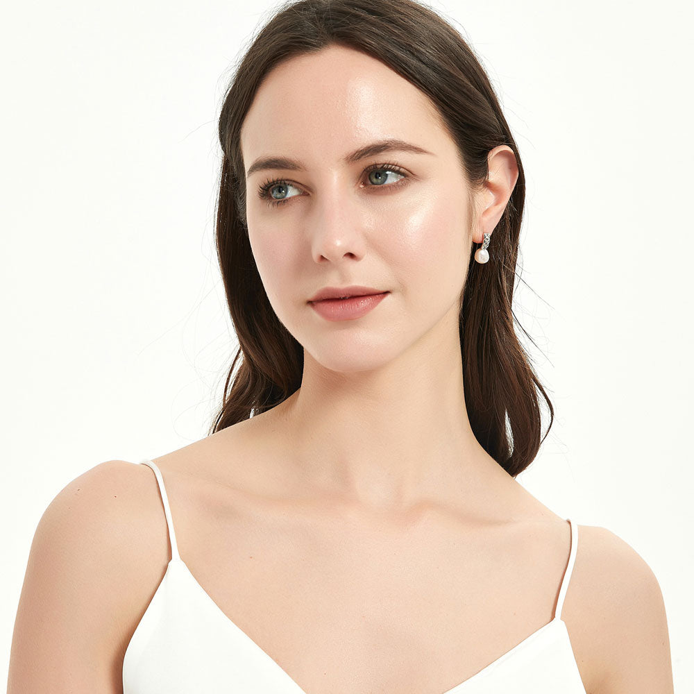 Model wearing Solitaire Baroque Cultured Pearl Stud Earrings in Sterling Silver, Yellow Gold Flashed