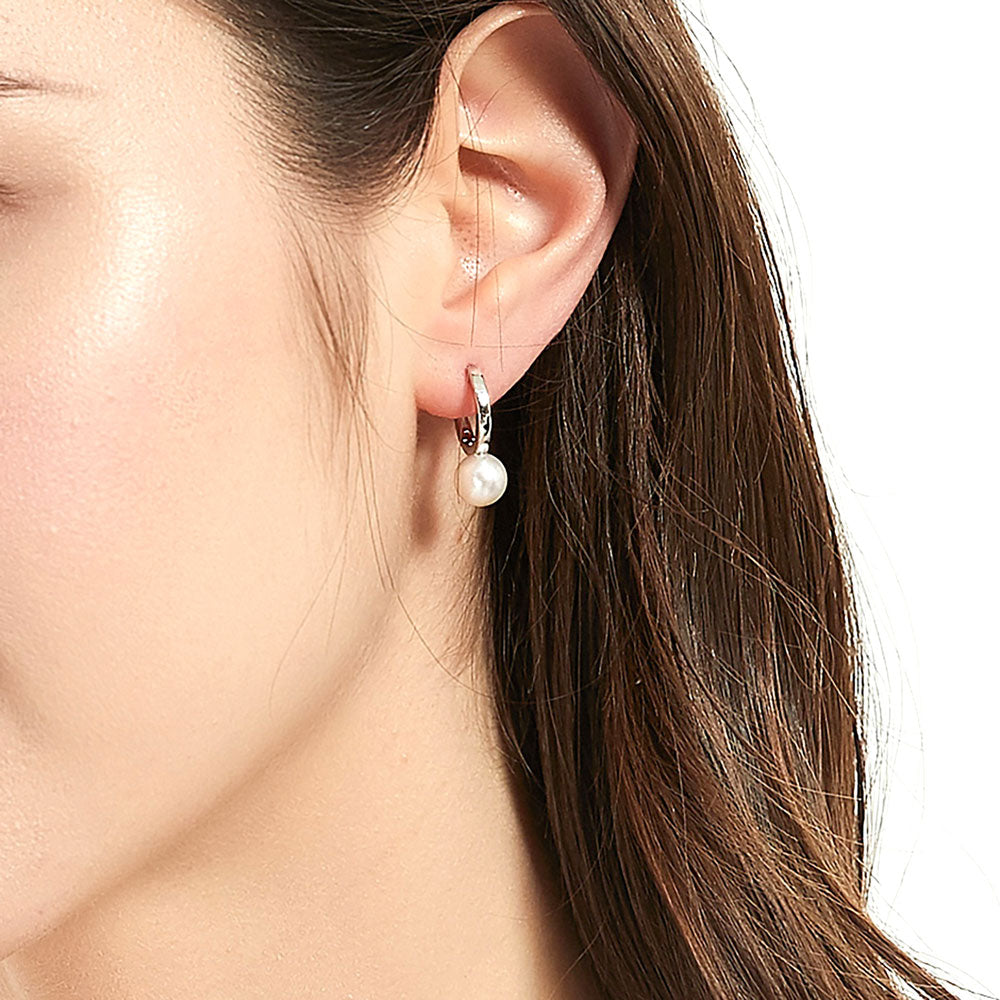Model wearing Solitaire Round Cultured Pearl Huggie Earrings in Sterling Silver 0.8 inch, 7 of 9