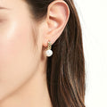 Model wearing Solitaire Baroque Cultured Pearl Stud Earrings in Sterling Silver, Yellow Gold Flashed