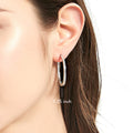 Model wearing Bar CZ Small Hoop Earrings in Sterling Silver, 1.25 inch