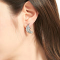 Model wearing Feather CZ Stud Earrings in Sterling Silver, Rhodium Plated