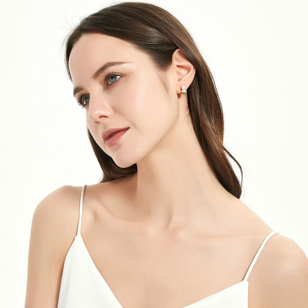 Model wearing Solitaire White Button Cultured Pearl Stud Earrings in Sterling Silver, 4 of 7