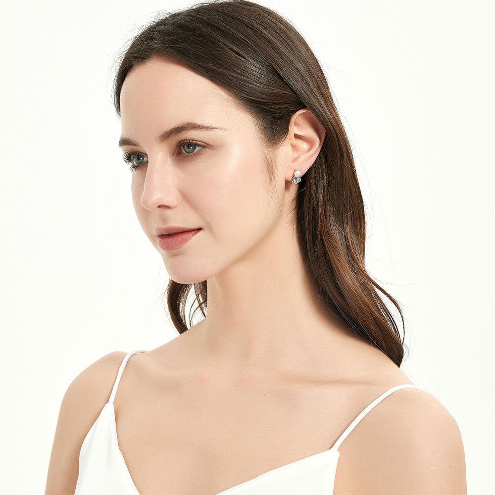 Model wearing Solitaire White Button Cultured Pearl Stud Earrings in Sterling Silver, 5 of 7