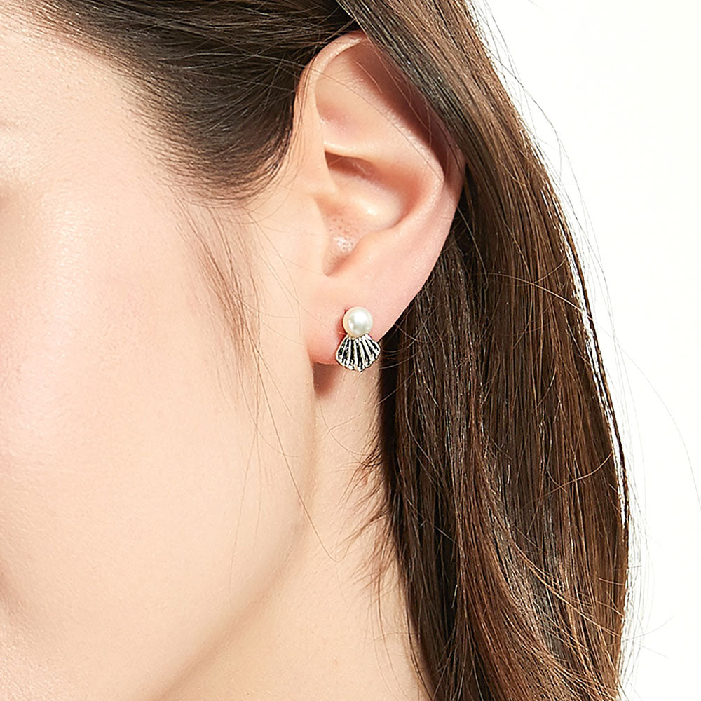 Model wearing Solitaire White Button Cultured Pearl Stud Earrings in Sterling Silver, 3 of 7