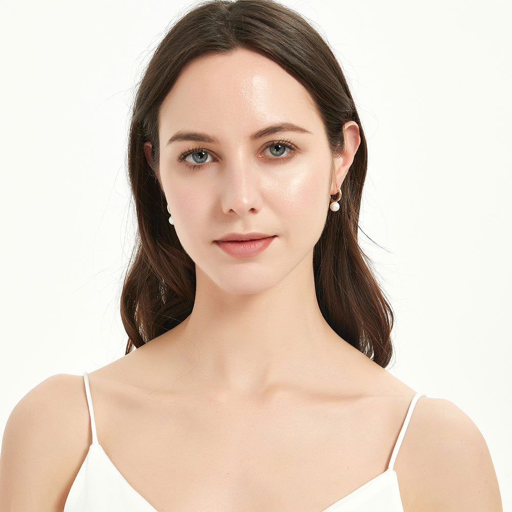 Model wearing Solitaire Round Cultured Pearl Huggie Earrings in Sterling Silver 0.8 inch, 6 of 9