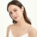 Model wearing Solitaire Baroque Cultured Pearl Stud Earrings in Sterling Silver, Yellow Gold Flashed
