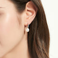 Model wearing Solitaire Baroque Cultured Pearl Stud Earrings in Sterling Silver, Rhodium Plated