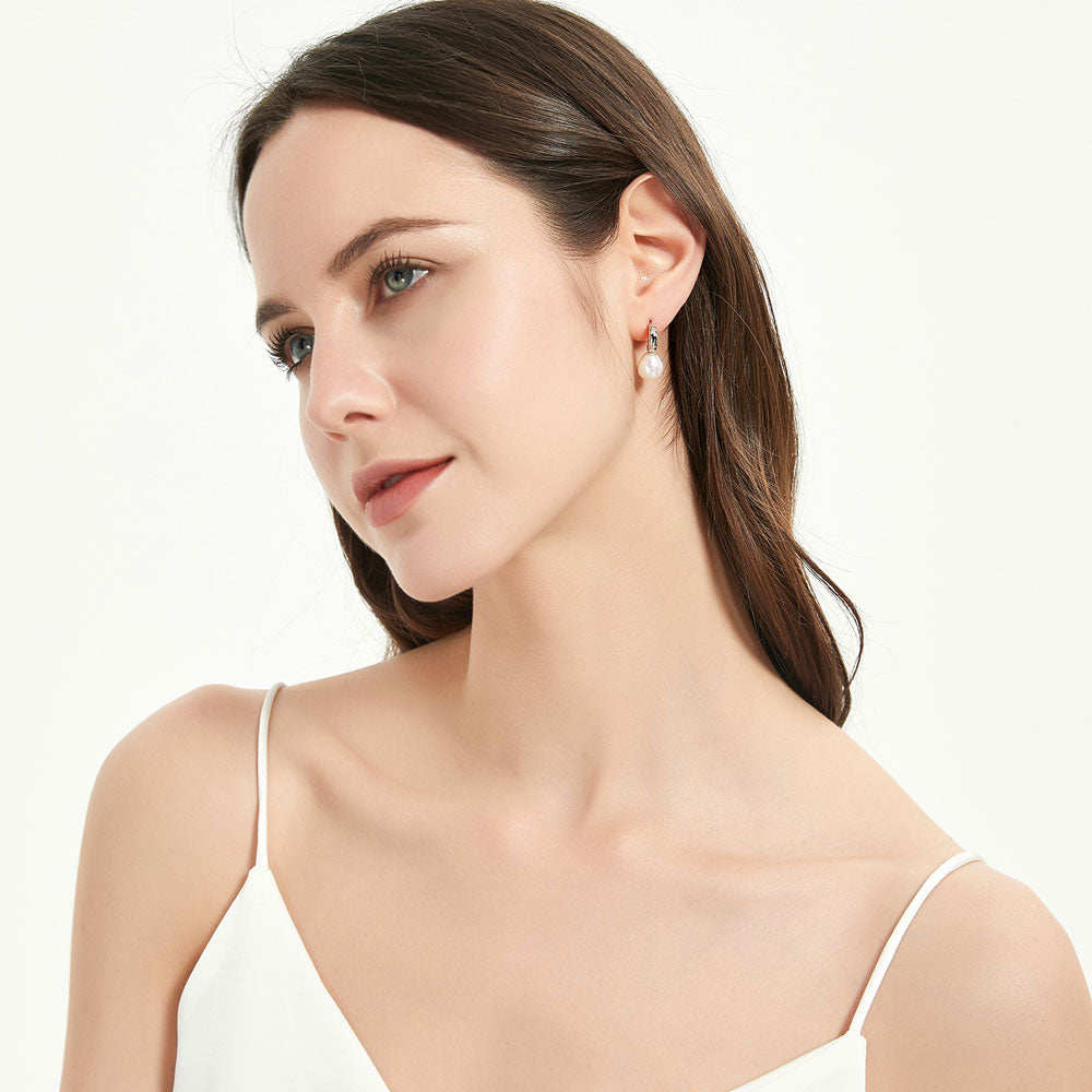 Model wearing Solitaire Baroque Cultured Pearl Stud Earrings in Sterling Silver, Rhodium Plated