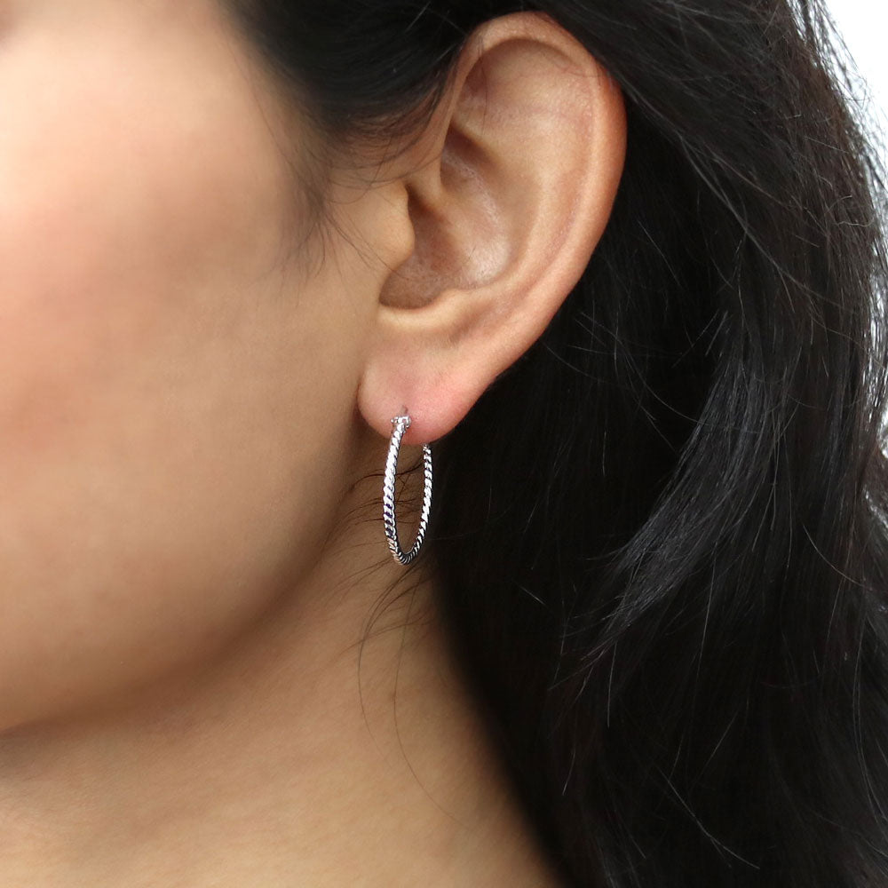 Model wearing Cable Medium Hoop Earrings in Sterling Silver 0.88 inch, 5 of 10