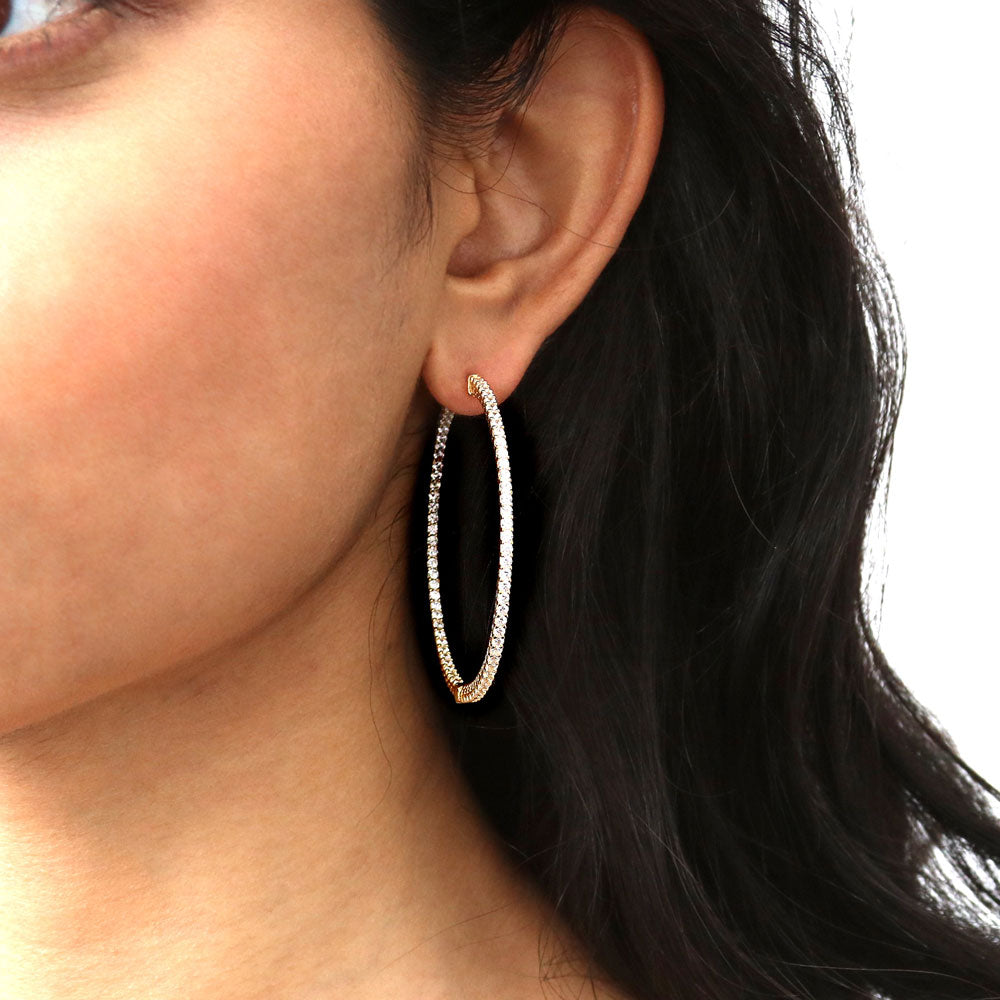 Model wearing CZ Large Inside-Out Hoop Earrings in Sterling Silver 2 inch, Yellow Gold Flashed