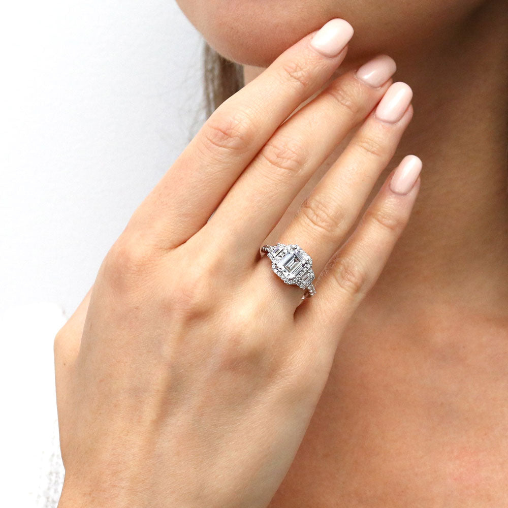 Model wearing 3-Stone Halo Step Emerald Cut CZ Ring in Sterling Silver, 2 of 11