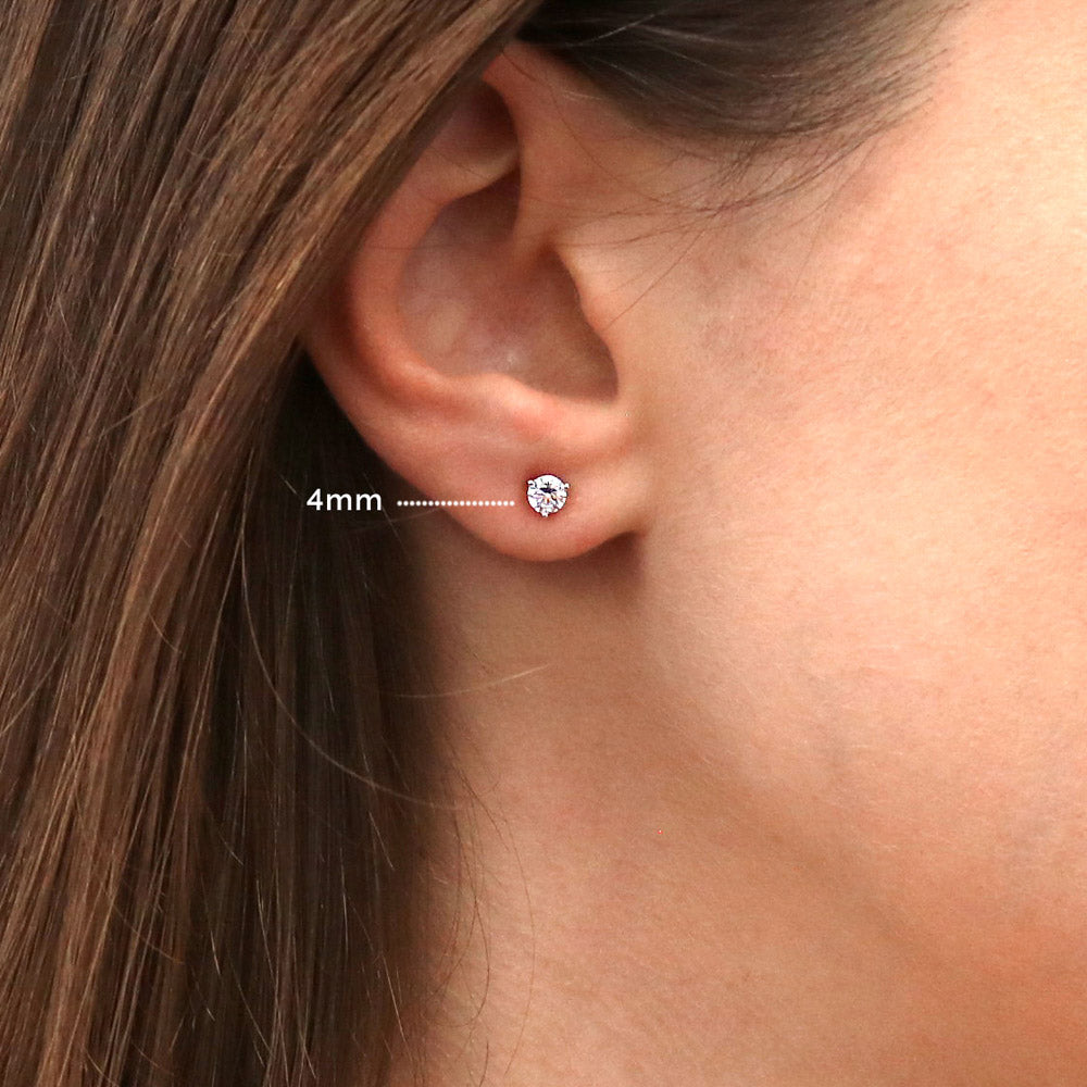 Model wearing Solitaire Round CZ Stud Earrings in Sterling Silver, 8 of 9