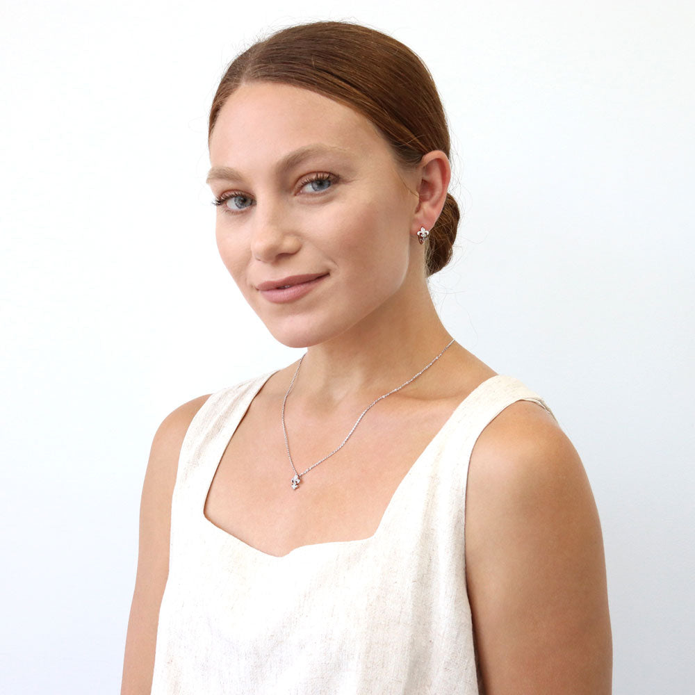 Model wearing Fleur De Lis CZ Necklace and Earrings Set in Sterling Silver