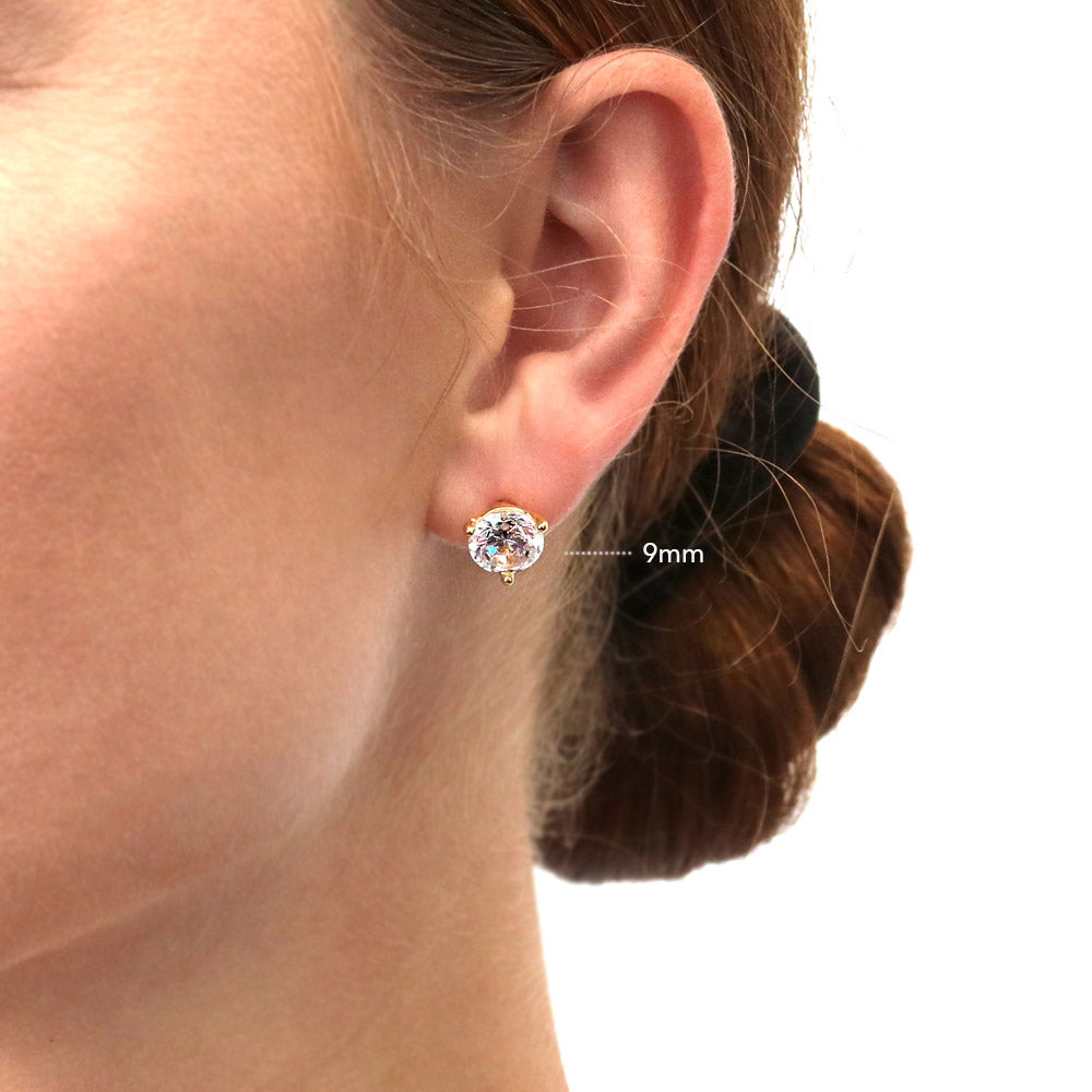 Model wearing Solitaire Round CZ Stud Earrings in Gold Flashed Sterling Silver, 2 of 15