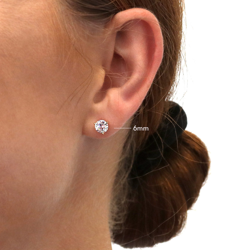 Model wearing Solitaire Round CZ Stud Earrings in Gold Flashed Sterling Silver, 12 of 15