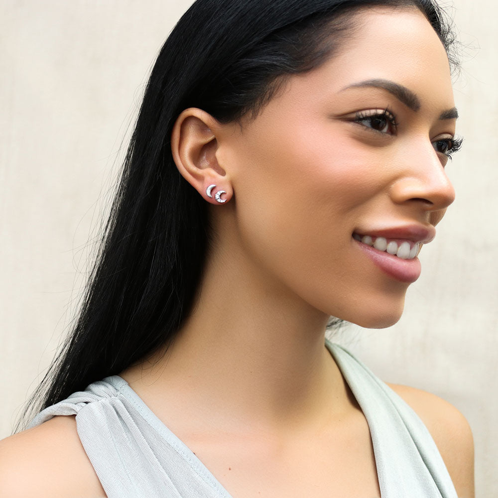 Model wearing Crescent Moon Cartilage Stud Earrings in Sterling Silver, Rhodium Plated