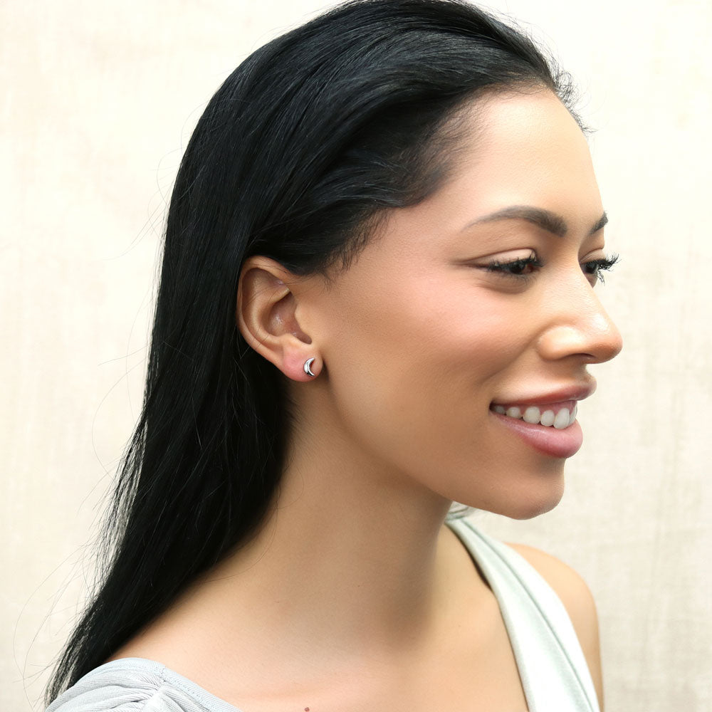 Model wearing Crescent Moon Stud Earrings in Sterling Silver, 7 of 11
