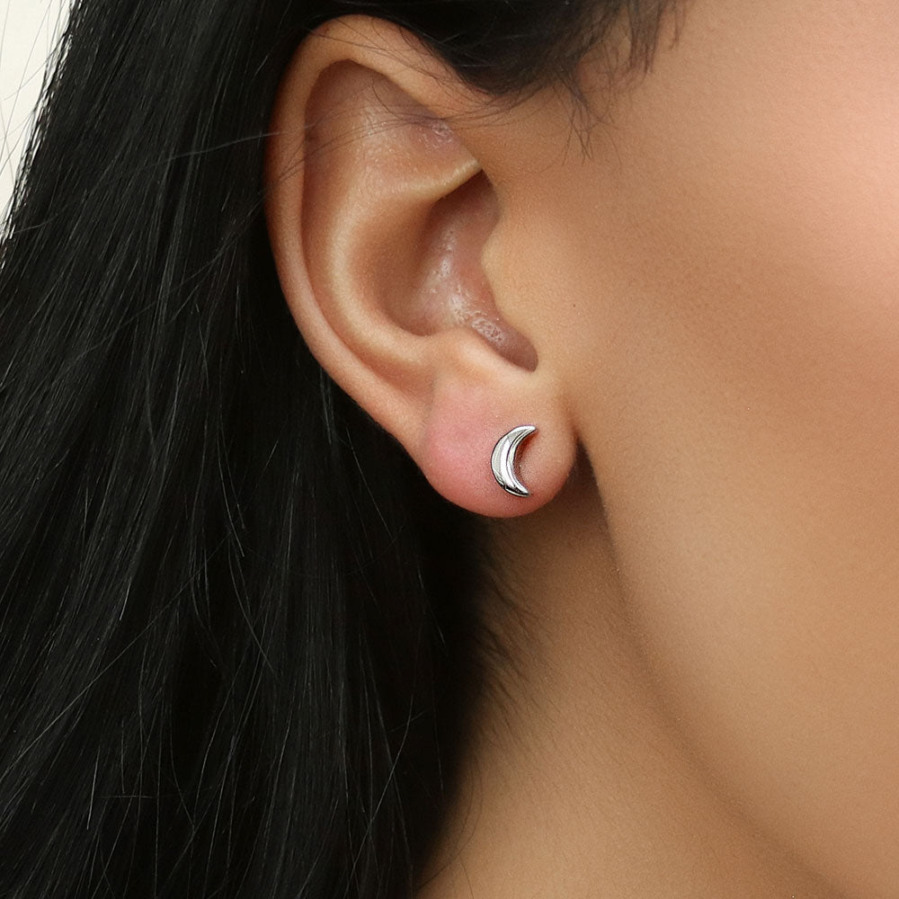 Model wearing Crescent Moon Stud Earrings in Sterling Silver, 5 of 11