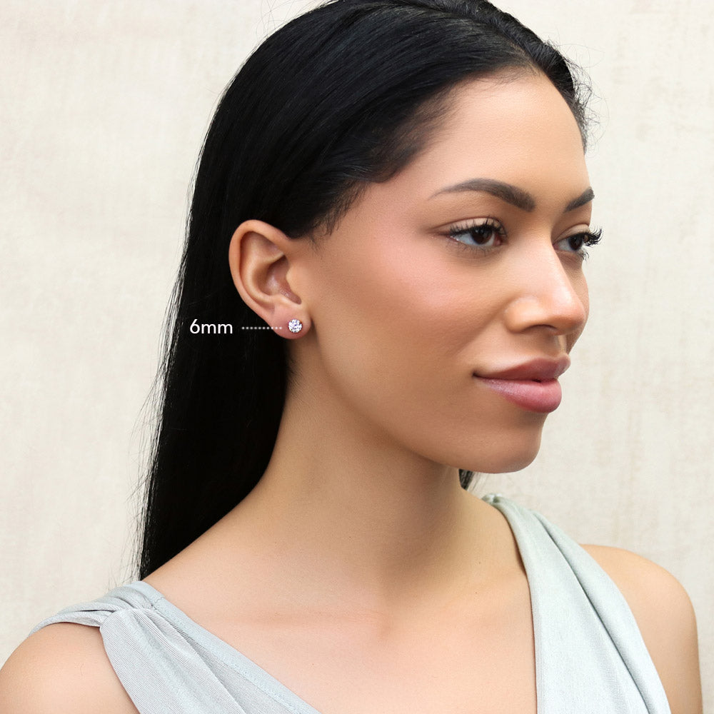 Model wearing Solitaire Round CZ Stud Earrings in Gold Flashed Sterling Silver, 2 of 14