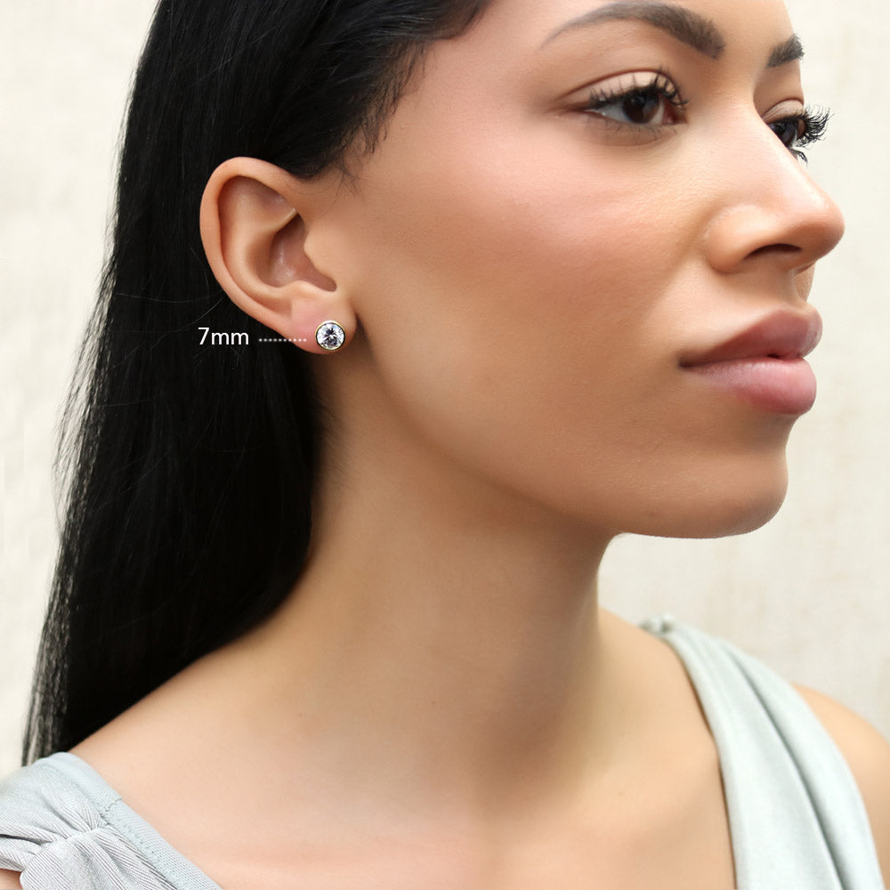 Model wearing Solitaire Bezel Set Round CZ Stud Earrings in Sterling Silver, 15 of 20