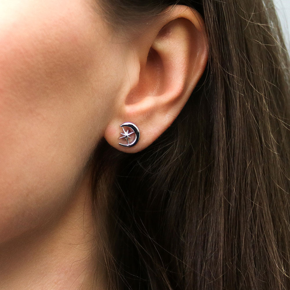 Model wearing Crescent Moon North Star Stud Earrings in Sterling Silver, 2 of 8