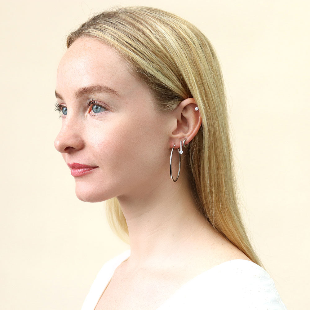 Model wearing Halo Solitaire Round CZ Stud Earrings in Sterling Silver, 2 Pairs, 16 of 19