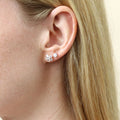 Model wearing Flower CZ Stud Earrings in Sterling Silver, Yellow Gold Flashed