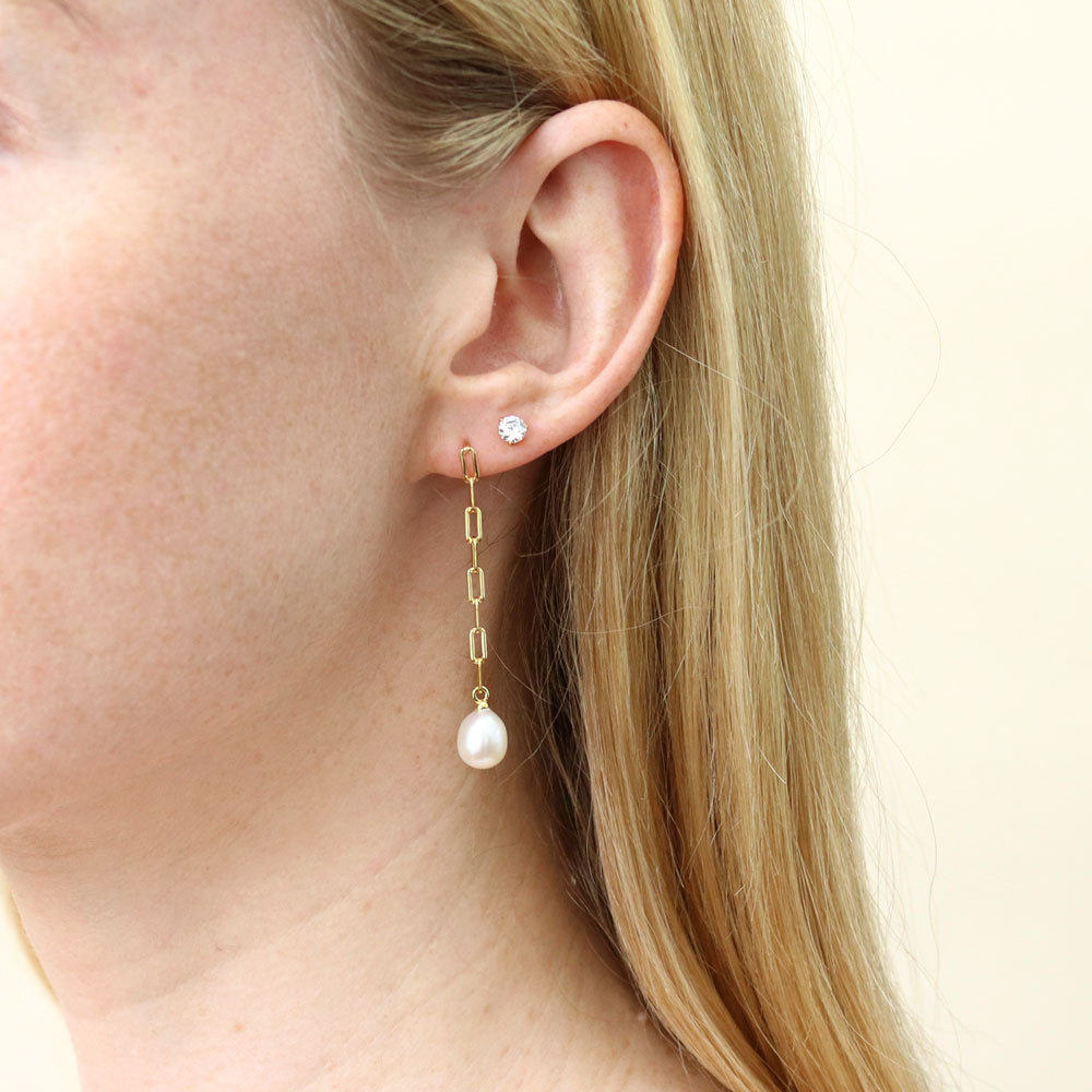 Model wearing Solitaire White Oval Cultured Pearl Earrings in Sterling Silver, 4 of 6