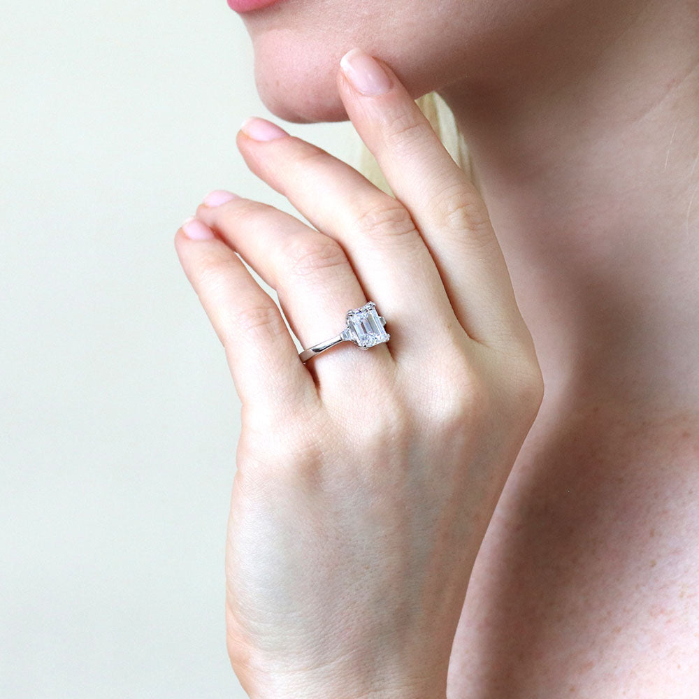 Model wearing 3-Stone 2.6ct Emerald Cut CZ Ring in Sterling Silver, 7 of 11