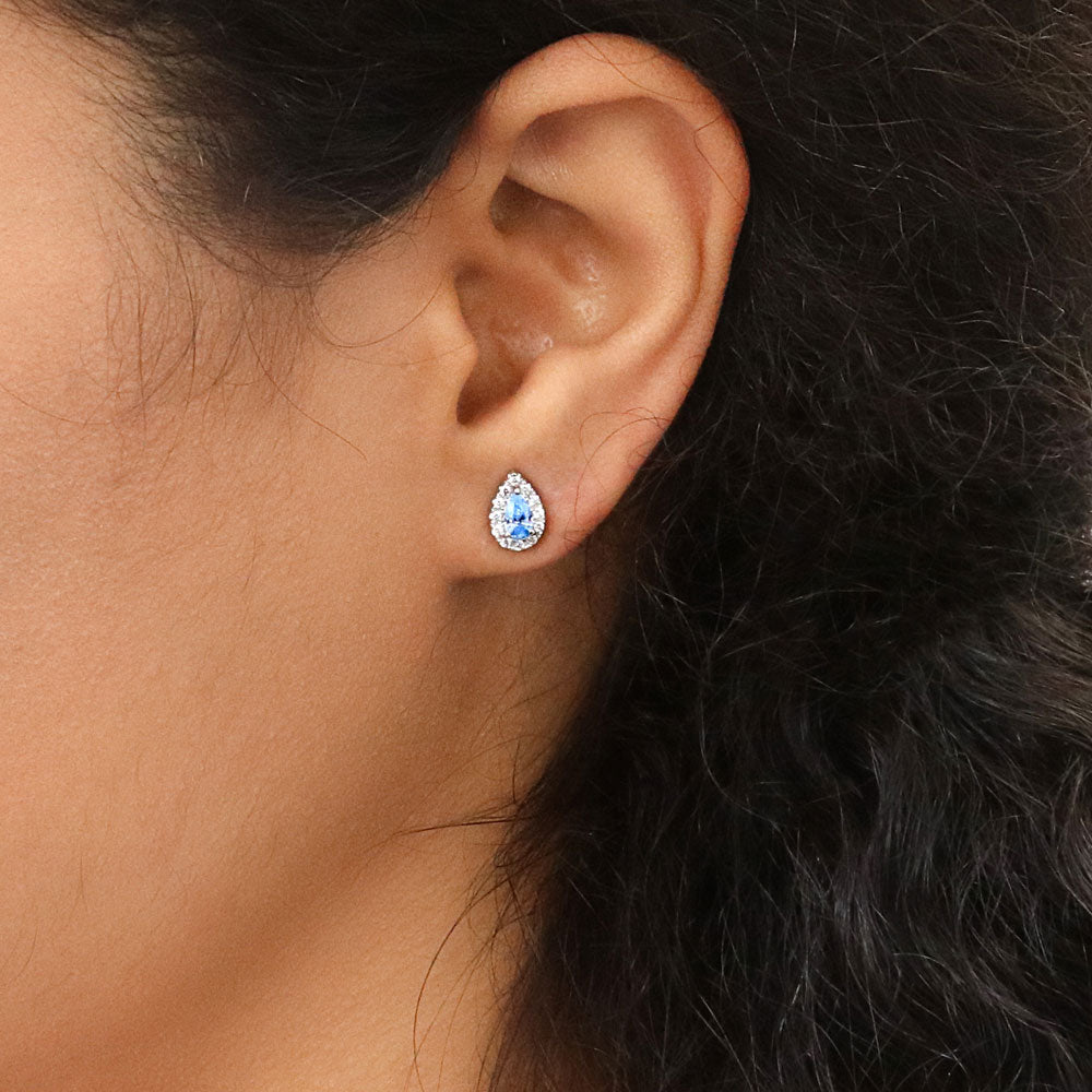 Model wearing Halo Pear CZ Stud Earrings in Sterling Silver, Green Color