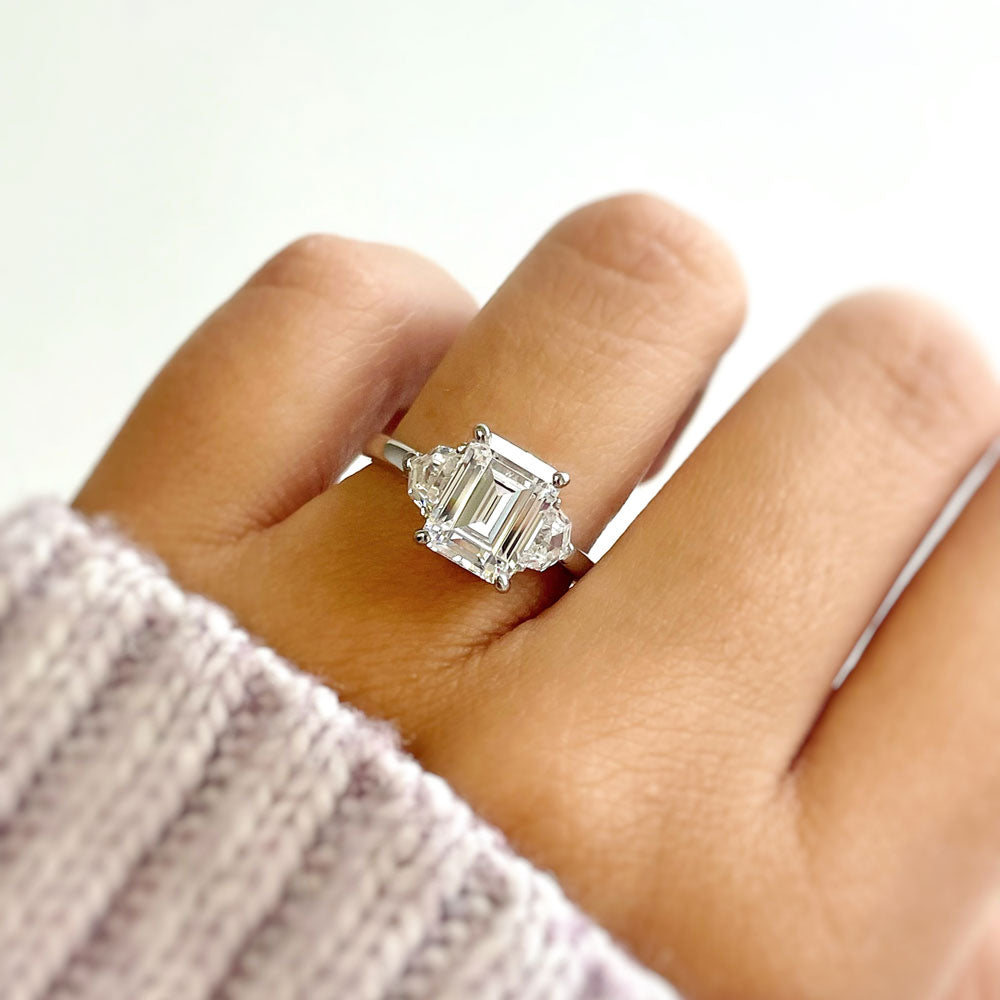 Model wearing 3-Stone 2.6ct Emerald Cut CZ Ring in Sterling Silver, 7 of 11