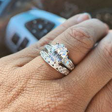 Model Wearing Curved Half Eternity Ring, Solitaire with Side Stones Ring